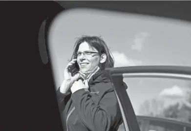  ?? PHOTOS BY COURTNEY HERGESHEIM­ER/ COLUMBUS DISPATCH ?? Sister Beata Tiboldi, a Dominican Sister of Peace, calls a client to see if they are home before delivering food with Meals on Wheels.