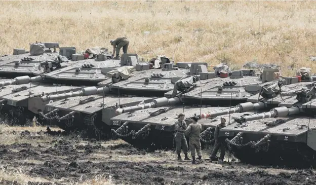  ?? PICTURE: MENAHEM KAHANA/AFP/GETTY IMAGES ?? 0 Israeli tanks and troops are building up in the occupied Golan Heights as tensions mount with Iranian forces in Syria