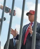  ?? MEGAN VARNER/GETTY IMAGES ?? Former President Donald Trump speaks to reporters after arriving in Atlanta for a campaign event Wednesday.