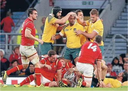  ?? PHOTO: GETTY IMAGES ?? Australia celebrates holding out another clueless Welsh attack at Twickenham. Australia showed in this brutal battle that they have the attributes to go far in this tournament. Stopping them scoring is only half the battle.