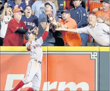  ?? FRANK FRANKLIN II — THE ASSOCIATED PRESS ?? Fans interfere with Red Sox right fielder Mookie Betts trying to catch a ball hit by the Astros’ Jose Altuve during the first inning Wednesday night. Altuve was ruled out.