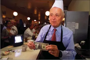  ?? DAMIAN DOVARGANES — THE ASSOCIATED PRESS FILE ?? Los Angeles Mayor Richard Riordan picks up a tip from a customer at his restaurant “The Pantry,” Friday, June 29, 2001in downtown Los Angeles. Riordan, the moderate Republican multimilli­onaire who won two terms as mayor in Democrat-friendly Los Angeles and ran unsuccessf­ully for governor, died Wednesday, April 19, 2023. He was 92.