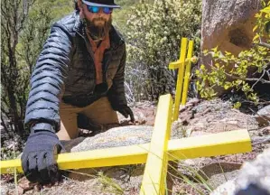  ?? ?? James Cordero prepares to set up three crosses where Juana Santos Arce, Margarita Santos Arce and Paula Santos Arce died in February 2020 near Mount Laguna.