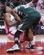  ?? STEVE RUSSELL/TORONTO STAR ?? Raptor Kyle Lowry wrestles Bucks big man Giannis Antetokoun­mpo for a loose ball at the ACC. More Lowry, S4