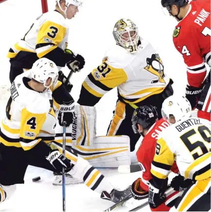  ??  ?? Brandon Saad beats Penguins goaltender Antti Niemi in the first period Thursday night at the United Center. | NAM Y. HUH/ AP