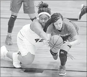  ?? Arkansas Democrat-Gazette/THOMAS METTHE ?? (left) of Hot Springs and Little Rock Parkview’s Jordyn Williams fight for a loose ball Saturday during the Lady Trojans’ 67-53 victory over the Lady Patriots in the semifinals of the Class 5A girls state tournament in Maumelle.