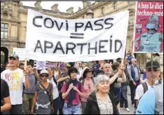  ?? AP PHOTO/MICHEL EULER ?? Anti-vaccine protesters march with a banner during a rally in Paris, Saturday, July 17, 2021. A Holocaust survivor, French officials and anti-racism groups are denouncing anti-vaccinatio­n protesters who are comparing themselves to Jews persecuted by the Nazis.