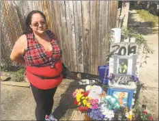  ?? John Nickerson / Hearst Connecticu­t Media ?? Emily Soto, 28, of Stamford, standing next to the memorial to Leobardo Quintero, who died after being pushed to the ground on lower Alden Street last week.