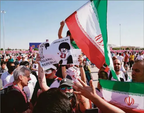  ?? AP Photo / Jin-Man Lee ?? Protesters and supporters of the Iranian soccer team clash at a World Cup match in Qatar on Friday, Nov. 25.