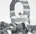  ?? ASSOCIATED PRESS
MATT ROURKE/ ?? David Reinert holds a Q sign as he waits in line with others to enter a campaign rally for President Donald Trump and U.S. Senate candidate Rep. Lou Barletta, R-Pa., in August 2018 in Wilkes-Barre, Pa.