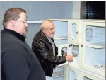  ?? Doug Walker / Rome News-Tribune ?? Assistant City Manager Patrick Eidson (left) and SPLOST Citizens Advisory Committee member J.C. Boehm examine cat kennels in the new shelter which is expected to start taking animals next week.