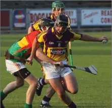  ??  ?? Wexford midfielder Eoin Moore breaking through a challenge.