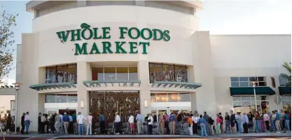  ??  ?? FLORIDA: In this Oct 26, 2005 file photo, shoppers line up outside a Whole Foods Market before it opens for the day in Palm Beach Gardens. —AP