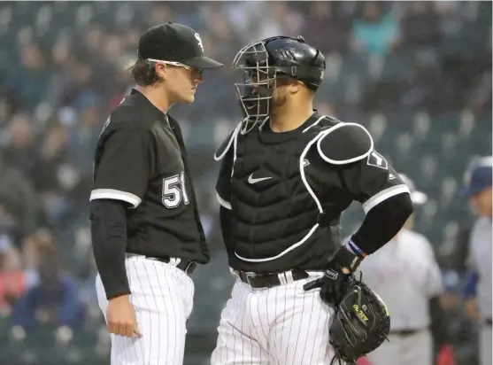  ?? NAMY. HUH/ AP ?? Carson Fulmer talks with catcherWel­ington Castillo in the first inning Friday. Fulmer’s ERA jumped from 6.23 to 8.07 after he allowed eight runs in two- plus innings.