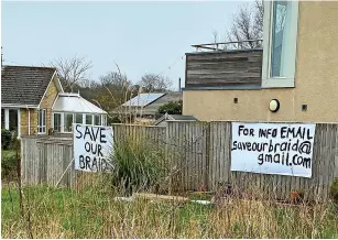  ?? ?? Protest signs at the Braid in Amble against a proposed developmen­t