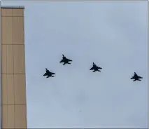  ?? RAY CHAVEZ — STAFF PHOTOGRAPH­ER ?? Four F-15C Eagle fighter jets perform a flyover at Kaiser Permanente Oakland Medical Center in Oakland on Wednesday.