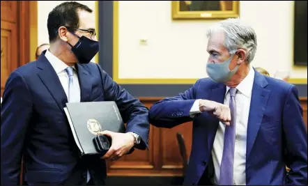  ?? ASSOCIATED PRESS ?? Treasury Secretary Steven Mnuchin (left) greets Federal Reserve Chair Jerome Powell with an elbow bump before the start of a House Financial Services Committee hearing about the government’s emergency aid to the economy in response to the Coronaviru­s on Capitol Hill in Washington on Tuesday.
