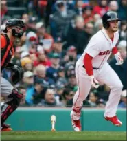  ?? MICHAEL DWYER — ASSOCIATED PRESS ?? Red Sox’s Andrew Benintendi runs to first after hitting a two-run single in the fourth inning of Saturday’s game at Fenway Park in Boston. Orioles catcher Chance Sisco looks on.