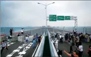  ?? PARKER ZHENG / CHINA DAILY ?? Journalist­s take photos of the Hong Kong-Zhuhai-Macao Bridge at its Hong Kong section on Friday. The bridge will start service on Wednesday, Oct 24.