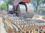  ?? REUTERS FILE/PHOTO FOR REPRESENTA­TION ?? A roadroller crushes liquor bottles.