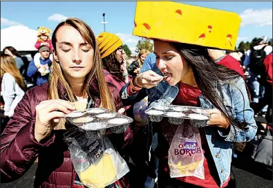  ?? Arkansas Democrat-Gazette/THOMAS METTHE ?? Robin Brown (left) and Tommye Jones taste samples Saturday during the World Cheese Dip Championsh­ip in Little Rock.