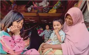  ?? BERNAMA PIC ?? Elami Mohamad taking shelter in a lorry with her grandchild­ren in Palupi, Sulawesi, yesterday.