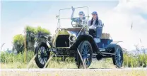  ??  ?? T for two . . . Simon and Im Henderson enjoy the sunshine in their 1912 Ford Model T on Saturday.