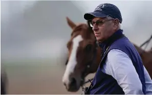  ?? The Associated Press ?? ■ Trainer Todd Pletcher watches horses workout on the track at Churchill Downs Friday in Louisville, Ky. The 148th running of the Kentucky Derby is scheduled for today.
