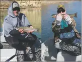  ?? COURTESY NEW MEXICO DEPARTMENT OF GAME & FISH ?? Robert Bass of Eagle Mountain, Utah, and his dad, Bob Bass of Farmington, caught multiple trout in the 16-20-inch range Feb. 21 on the San Juan River.
