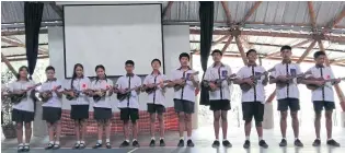  ??  ?? ABOVE Mechai Pattana students play ukuleles to entertain and introduce the school to visitors. Guests visit almost every day.