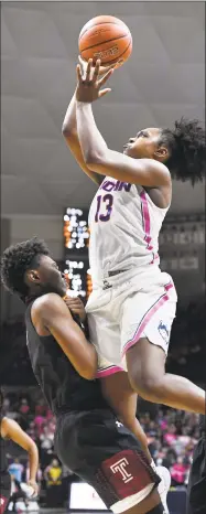  ?? Jessica Hill / Associated Press ?? UConn’s Christyn Williams is fouled by Temple’s Breanna Perry, left, as Williams takes a shot during the second half on Saturday.