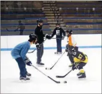  ?? SUBMITTED PHOTO ?? Members of the Hill School ice hockey team skate with young players in the Pottstown Penguins program. Hill Hockey Helps, a philanthro­pic organizati­on created by Hill senior Vincent Petrone, is lending its support to the Penguins and Pottstown PAL throughout the year with clinics and fundraisin­g.