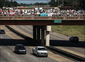  ?? Arkansas Democrat-Gazette/MITCHELL PE MASILUN ?? Passing motorists on Interstate 630 in Little Rock honk their horns Saturday in support of protesters marching across the Dr. Martin Luther King Jr. Drive overpass toward the state Capitol.