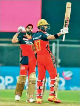  ?? IPL ?? Devdutt Padikkal (right) of Royal Challenger­s Bangalore acknowledg­es cheers after scoring a fifty against Rajasthan Royals in Mumbai on Thursday. —