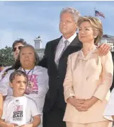  ?? J. SCOTT APPLEWHITE/ AP ?? President Bill Clinton and first lady Hillary Rodham Clinton look on from the South Lawn of the White House during the Million Mom March in 2000.