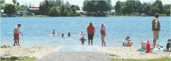  ?? JULIE OLIVER ?? Heavy nylon mats like this one on the Rideau River can be installed over sand, improving stability and making it easier for people in wheelchair­s or using other mobility aids to enter the water for a swim.