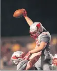  ?? TIM PHILLIS — FOR THE NEWS-HERALD ?? Riley Coughlin of Mentor is hoisted into the air by Hunter Colao after scoring a touchdown in the Cardinals’ 31-14 win over Stow-Munroe Falls.