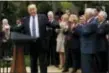  ?? ASSOCIATED PRESS ?? President Donald Trump, accompanie­d by GOP House members, speaks in the Rose Garden of the White House in Washington Thursday after the House pushed through a health care bill.