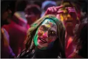  ?? (AP/Anupam Nath) (AP/Rajesh Kumar Singh) ?? A girl smeared with colors celebrates Holi on Wednesday on a street in Guwahati.