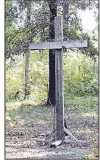  ?? Arkansas Democrat-Gazette/ FRANCISCA JONES ?? This wooden cross, which was on the grounds of Westminste­r Presbyteri­an Church, remained untouched while flames consumed the structure July 19.