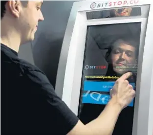  ?? MIKE STOCKER/STAFF PHOTOGRAPH­ER ?? Andrew Barnard, the co-founder of BitStop ATM machines, shows how his machines are used at World Foreign Exchange in Miami. The machines are placed in 50 South Florida locations.