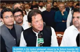  ?? — AFP ?? ISLAMABAD: In this handout photograph released by the National Assembly (NA) on August 17, 2018, Pakistan’s newly appointed Prime Minister Imran Khan (C) addresses the lawmakers after been elected by National Assembly.