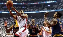  ?? Associated Press ?? Toronto Raptors guard Kyle Lowry scores against the Cleveland Cavaliers during first half of the Eastern Conference finals Monday in Toronto.