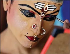  ?? REUTERS ?? A man gets ready backstage before performing in the 35th Cochin Carnival, which is held annually to welcome the start of the New Year at Fort Kochi in Kerala, on Tuesday.