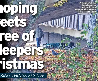  ?? ?? A member of the homelessne­ss outreach team engages with a rough sleeper in the city