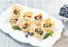  ?? TRACEY KUSIEWICZ ?? These phyllo cups are filled with blueberry goodness.