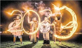  ?? DANNY LAWSON AP ?? Viking reenactors use flaming torches to write 2023 at the Flamboroug­h Fire Festival, a Viking themed parade in aid of charities and local community groups, held on New Year’s Eve in Flamboroug­h near Bridlingto­n, England, on Saturday.