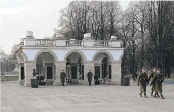  ?? ALIK KEPLICZ/AP ?? Soldiers are shown after changing the guard at the Tomb of the Unknown Soldier, the only remaining part of the Saski Palace, in Warsaw, Poland.