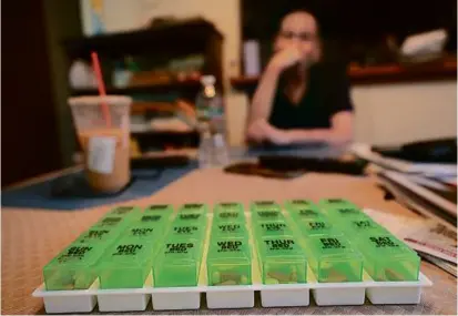  ?? ?? David Kornwolf in his kitchen with his medication­s. In the days since his September surgery, Kornwolf has been fully focused on his recovery.