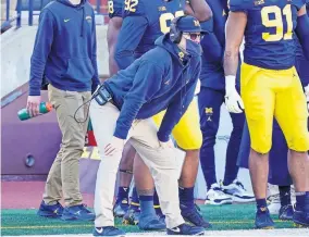  ??  ?? Michigan coach Jim Harbaugh watches from the sideline during the second half of 27-17 loss to Penn State on Saturday in Ann Arbor, Mich. [AP PHOTO/CARLOS OSORIO]